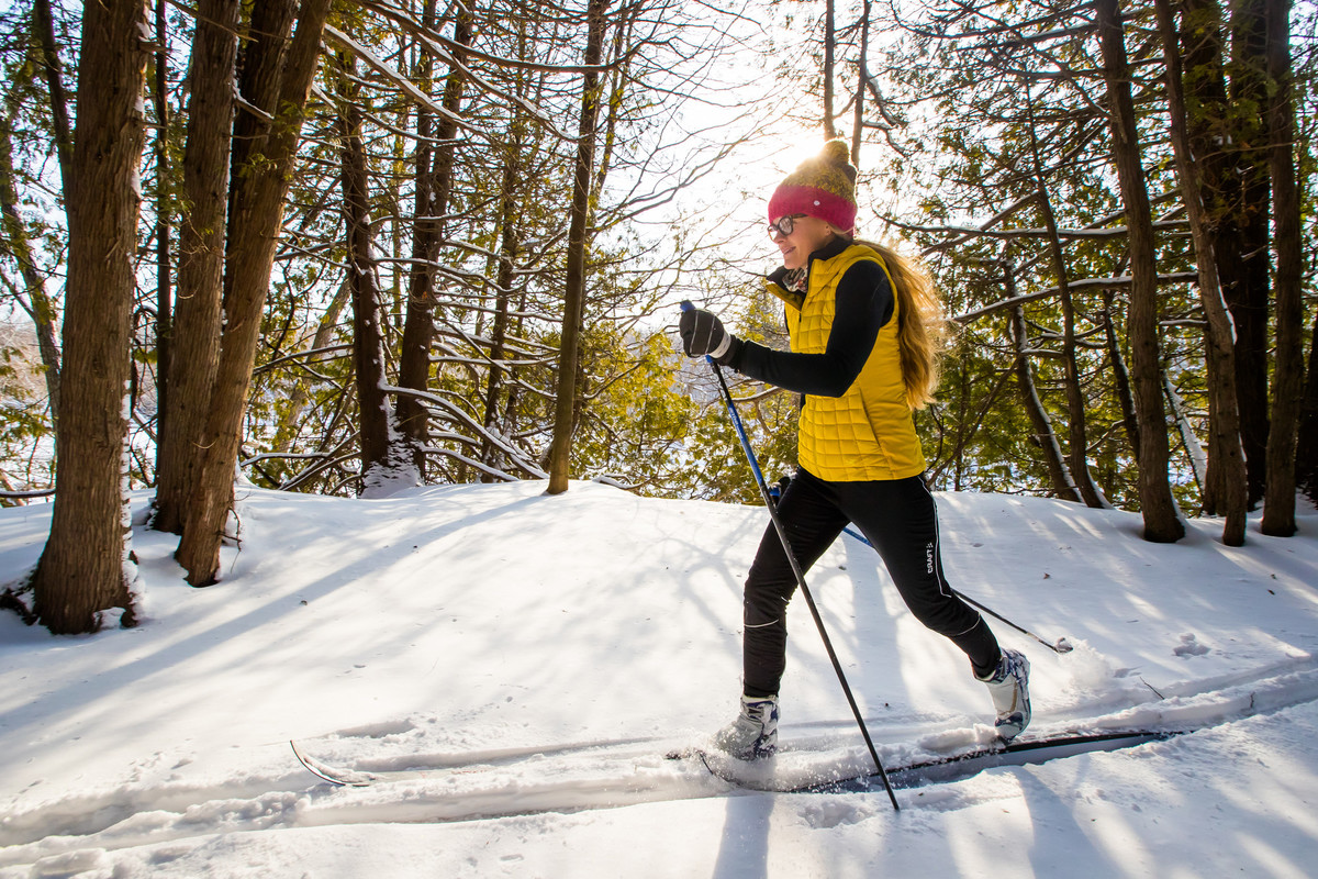 Woman cross country skiing in a forest