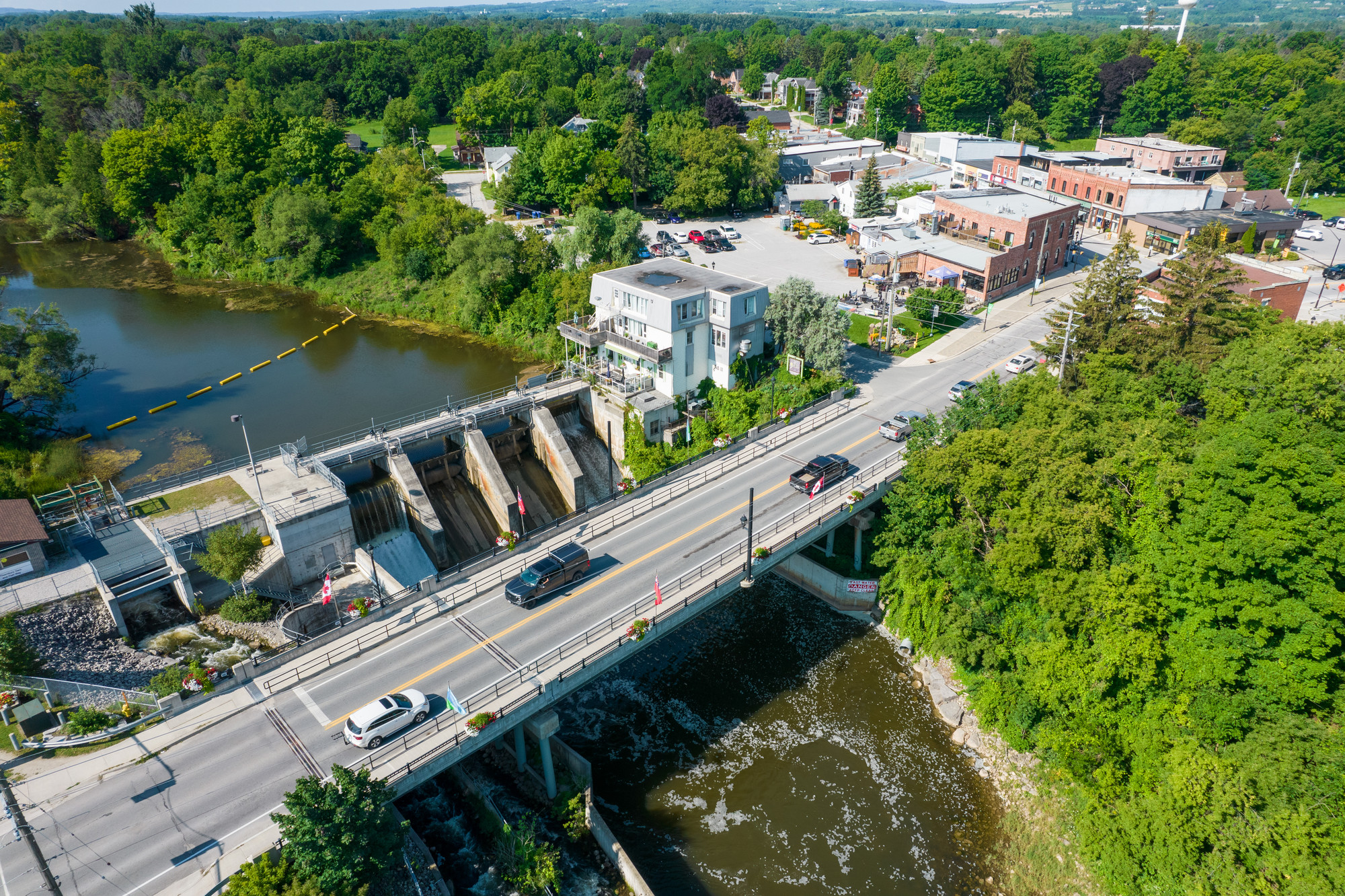 Aerial view of a small town with a bridge and dam.