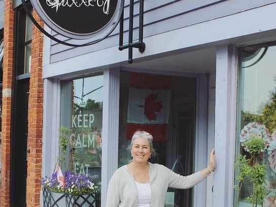 Casey Thomson Owner of Cheese Gallery in front of Shop