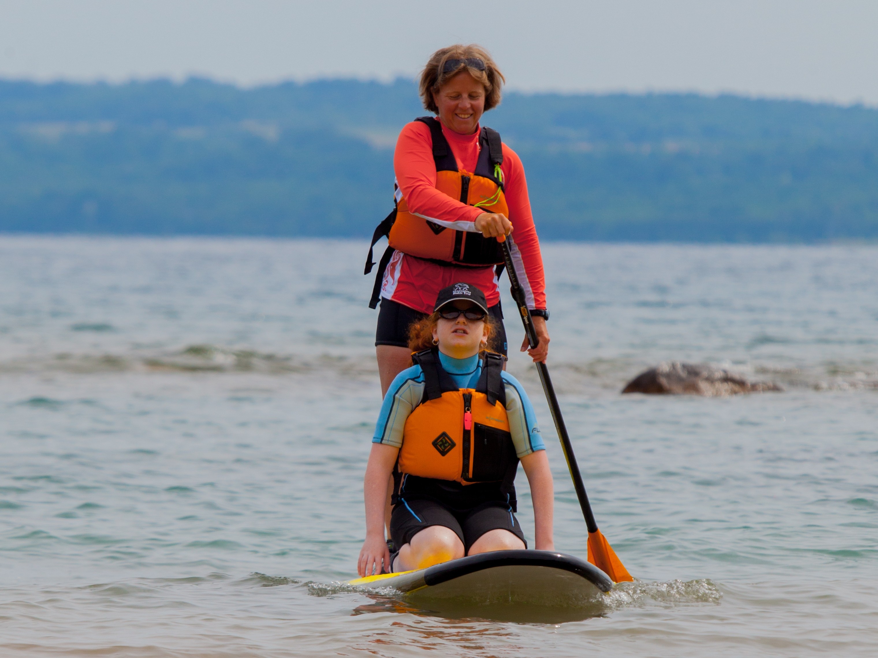 mother and daughter on stand-up paddleboard at Sarawak Beach