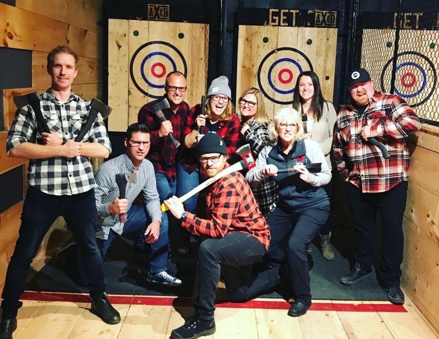 Group of happy people throwing axes