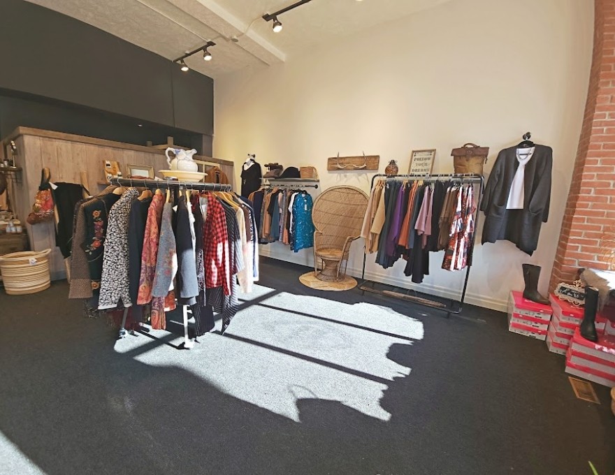 Interior of store showing clothing racks and other items for sale