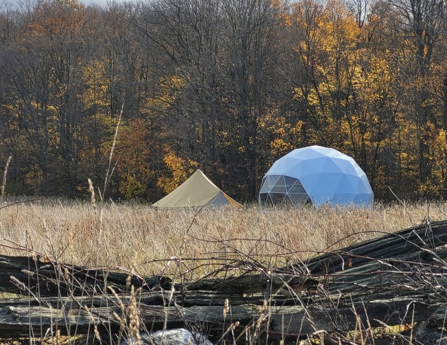 dome and tent in field