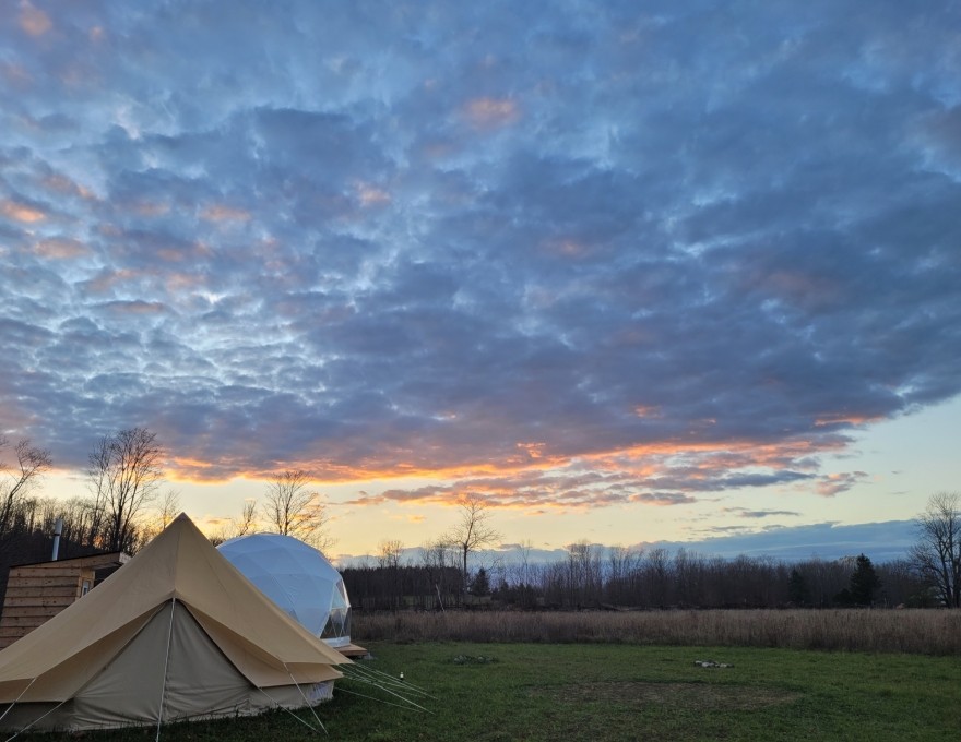 dome and tent in field with skyline