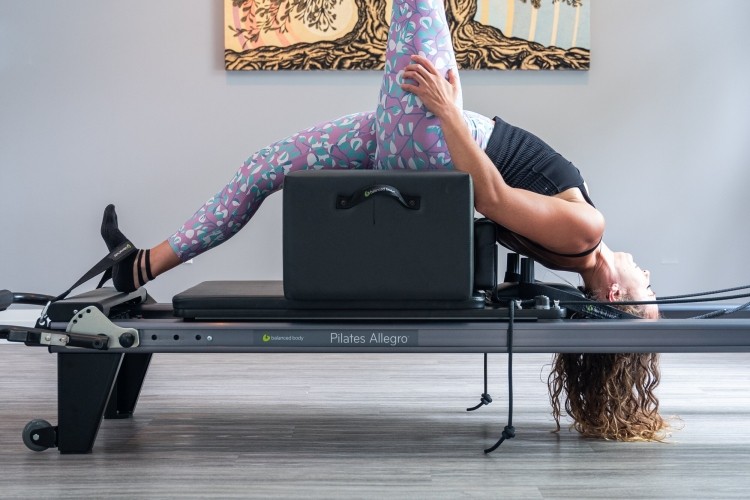 Girl doing reformer pilates 