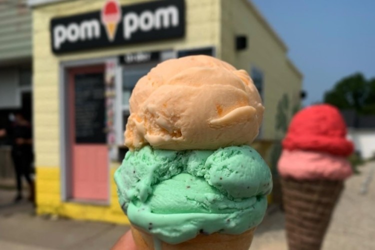 Pom Pom Ice Cream  People holding up ice cream in front of store