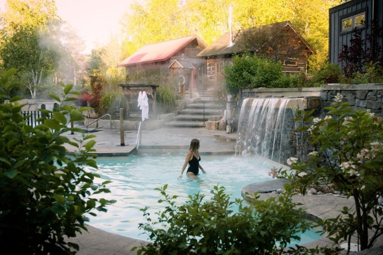 Woman in hot pool with waterfalls 