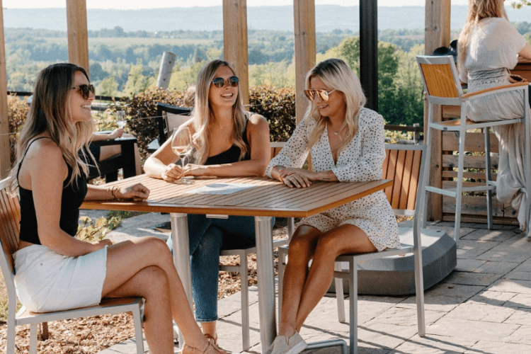 Girls at a table laughing and drinking
