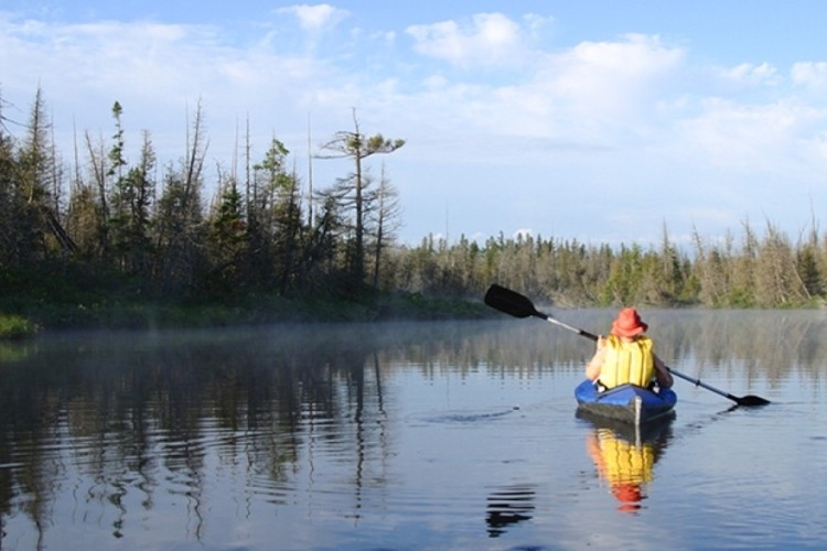 someone kayaking on a lake