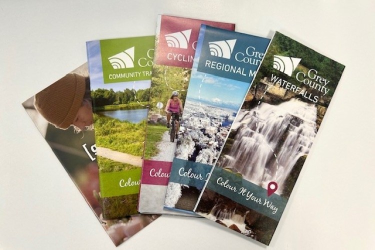 Guides and brochures layed out on white table
