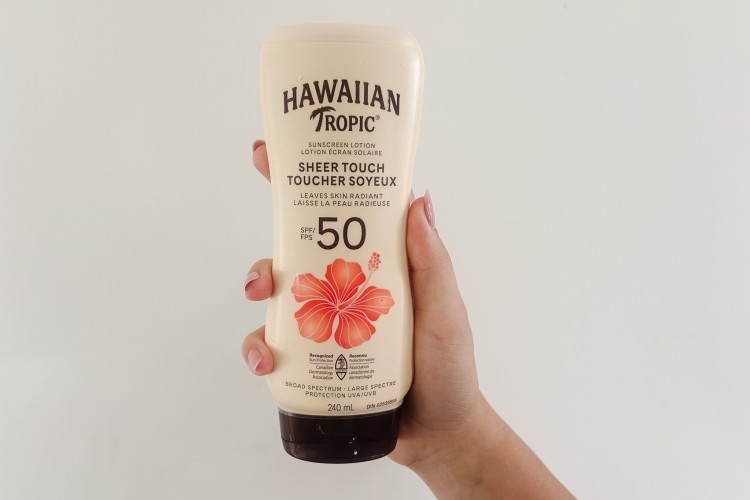Someone holding sunscreen 