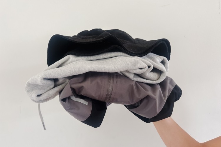 Someone holding a pile of clothes