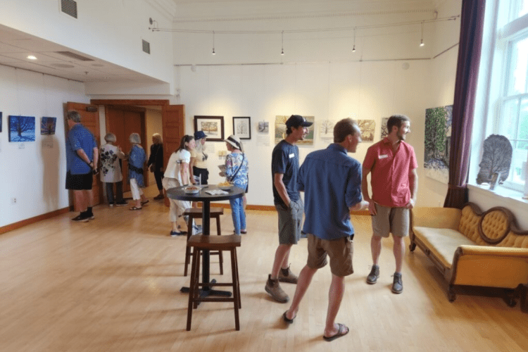 people looking at an art exhibit