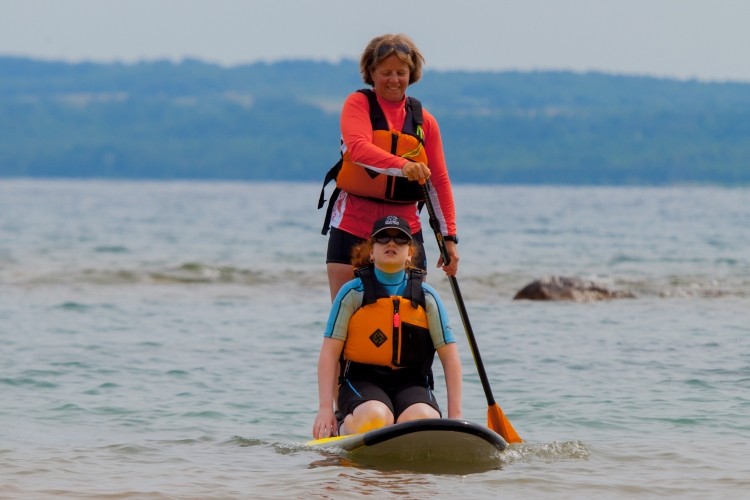 mother and daughter on stand-up paddleboard at Sarawak Beach