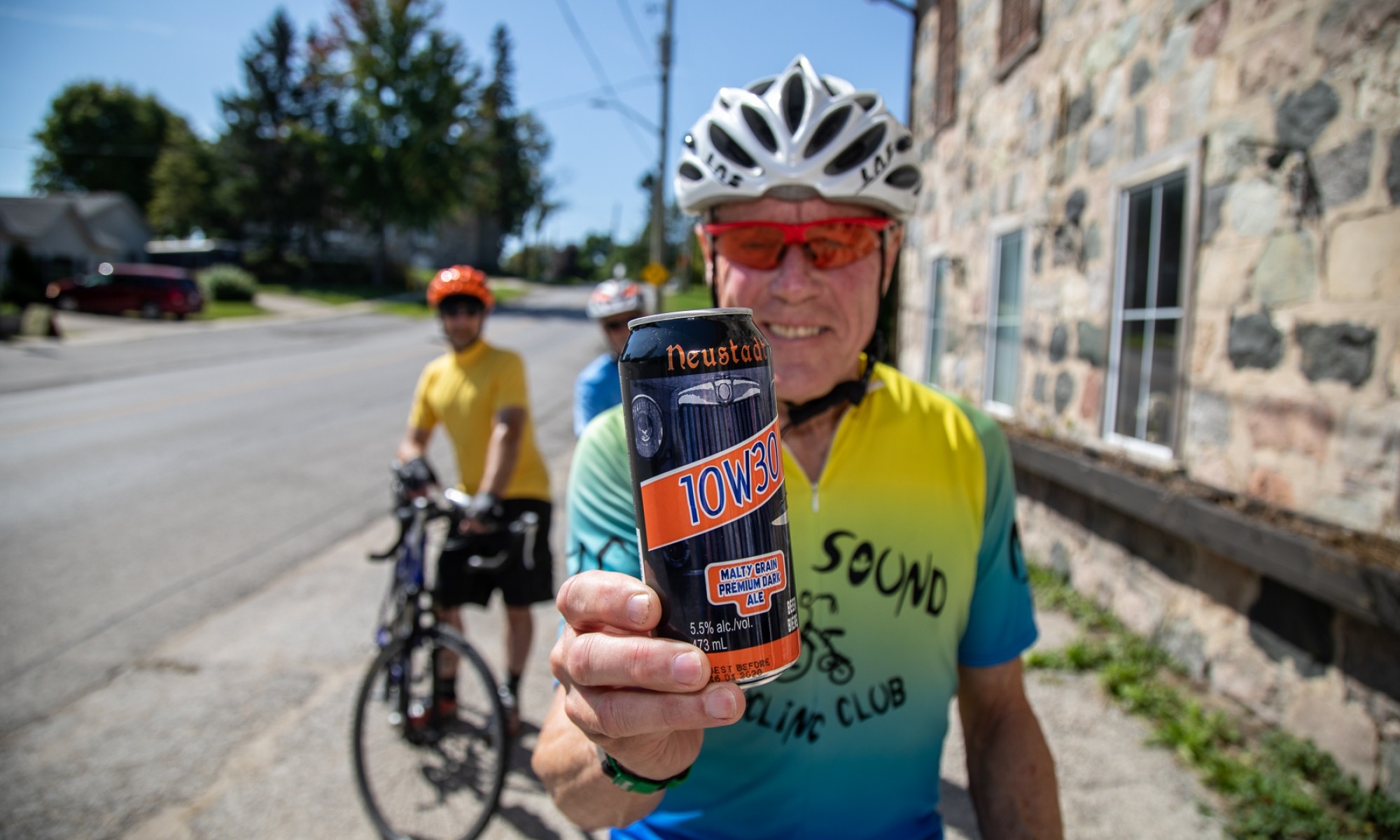 Neustadt Springs Brewery Man in cycling apparel holding beer can