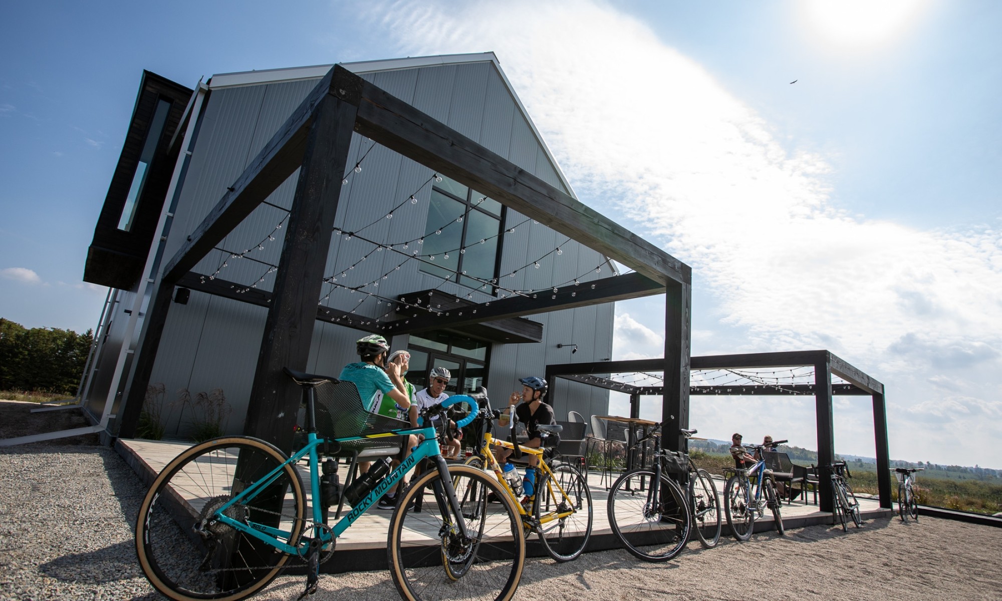 People enjoying cider on a patio