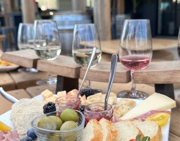 a table with wine glasses and food