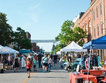 a crowd of people at a downtown market event 