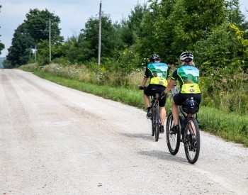 a couple of people biking on the road