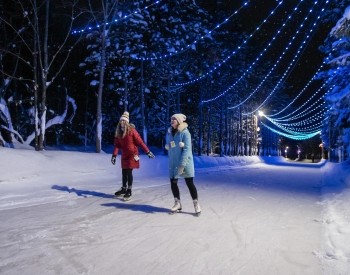 two women skating at night 