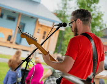 a man playing guitar on stage